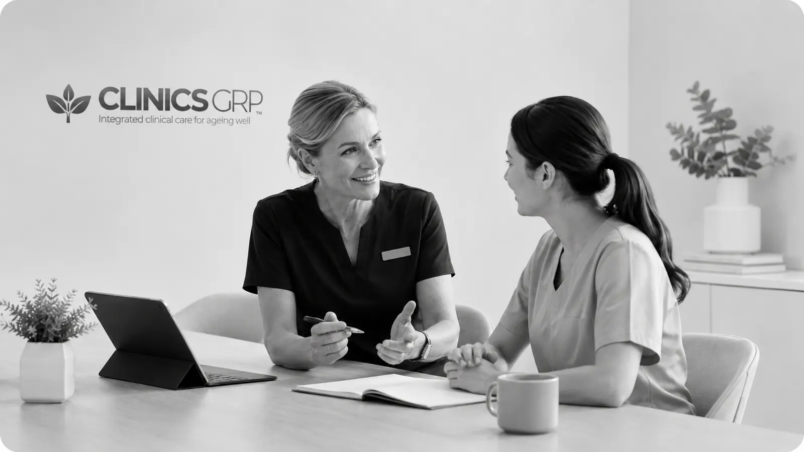 Two healthcare professionals discussing a Clinics GRP graduate physiotherapy application.