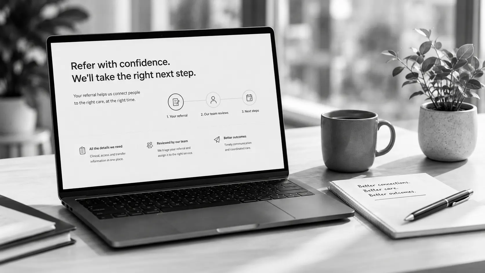 Referral pathway displayed on a laptop beside a notebook and coffee in a professional workspace.