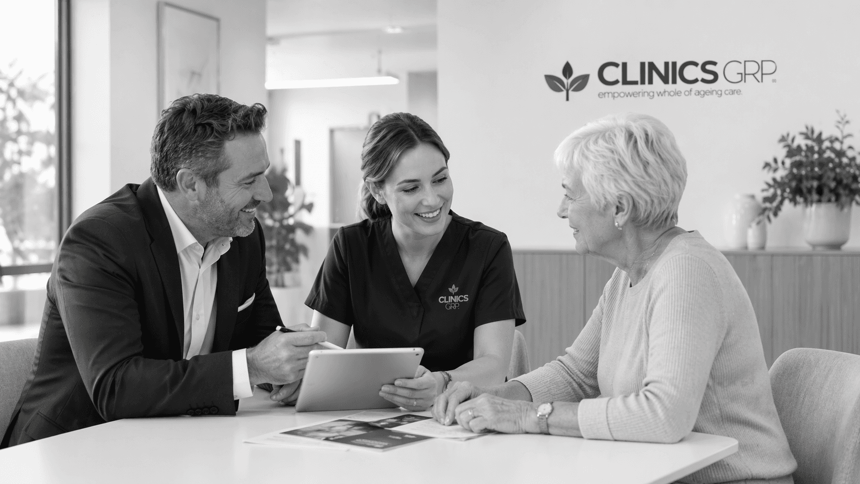 Clinics GRP clinician and team member speaking with an older adult in a care-planning setting.